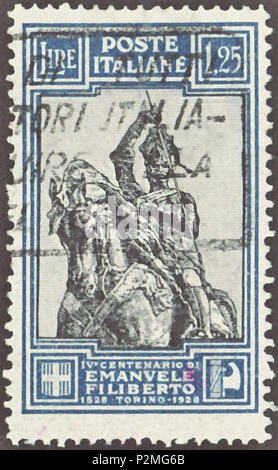 . Stamp of the Kingdom of Italy; 1928; commemorative stamp of the issue to the '400th anniversary of Emmanuel Philibert, Duke of Savoy (1528-1580)'; drawing of the duke from an equestrian monument in Turin of Emmanuel Philibert, Duke of Savoy during the Battle of Saint-Quentin in 1557; postmarked Stamp: Michel: No. 290B; Yvert & Tellier: No. 219; Scott: No. 209 Color: azure / black Watermark: Italy No. 1 (crown) Nominal value: 1.25 Lire Postage validity: from 27 July 1928 until 31 December 1929 Stamp picture size (printed area): 22.0 x 36.0 mm . 27 July 1928 first issue day of the stamp). Post Stock Photo