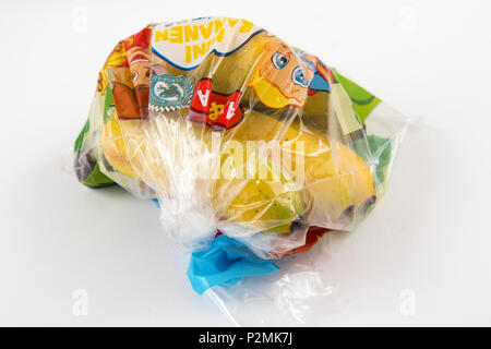 Fresh food, fruits, each individually packaged in plastic wrap, all food is available in the same supermarket even without plastic packaging, small ba Stock Photo