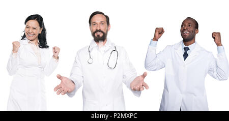 portrait of happy multicultural doctors in white coats isolated on white Stock Photo