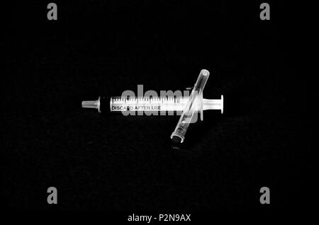 syringe isolated on black,monochrome image of a Stock Photo