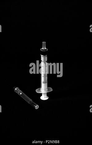 syringe isolated on black,monochrome image of a Stock Photo