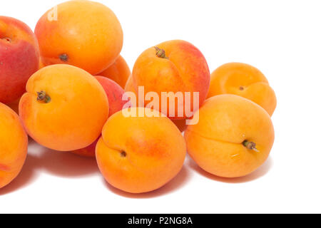 View of tasty Armenian plums (Prunus armeniaca) over a white wooden background. Stock Photo