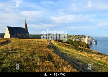 France, Seine Maritime, Pays de Caux, Cote d'Albatre (Alabaster Coast), Etretat, Notre Dame de la Garde chapel, protector of the fishermen, perched on Amont cliff and Aval cliff in the background Stock Photo