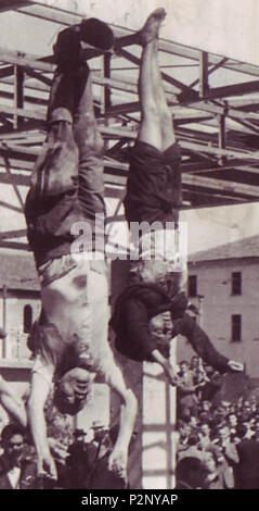 . English: The dead body of Benito Mussolini next to his mistress Claretta Petacci, on display in Milan on 29 April 1945, in Piazzale Loreto, the same place that the fascists had displayed the bodies of fifteen Milanese civilians a year earlier after executing them in retaliation for resistance activity. The photograph is by Vincenzo Carrese. The bodies, from left to right, are: Benito Mussolini Claretta Petacci  Deutsch: Die Leichen von Benito Mussolini und seiner Gefährtin Claretta Petacci in Mailand am 29. April 1945. Photo von Vincenzo Carrese. Von links nach rechts: Benito Mussolini Clare Stock Photo