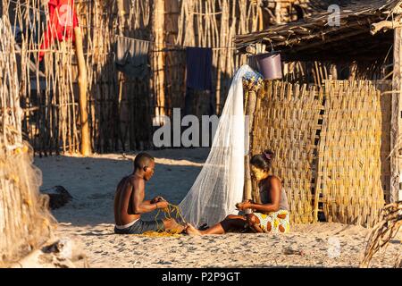 Madagascar, Menabe region, Morondava, a man and a woman repairing nets Stock Photo