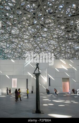 United Arab Emirates, Abu Dhabi, Saadiyat island, the Louvre Abu Dhabi is the first universal museum in the Arab world designed and built by French architect Jean Nouvel, bronze sculpture by Auguste Rodin, the Man walking on column (1913) under the light beams of the museum dome Stock Photo