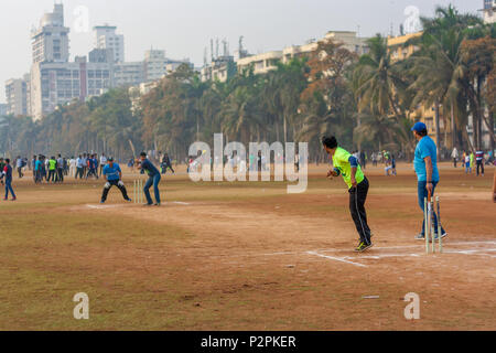 MUMBAI, INDIA - JANUARY 14, 2017 : Men playing cricket with tennis ball at Mumbai grounds Stock Photo