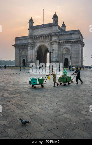MUMBAI, INDIA - JANUARY 14, 2017 -  Sweepers walking in front of Gateway of India after cleaning streets of Mumbai Stock Photo