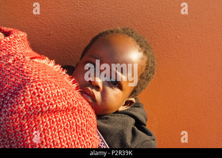 Swazi woman carrying baby on the back, Swaziland Stock Photo