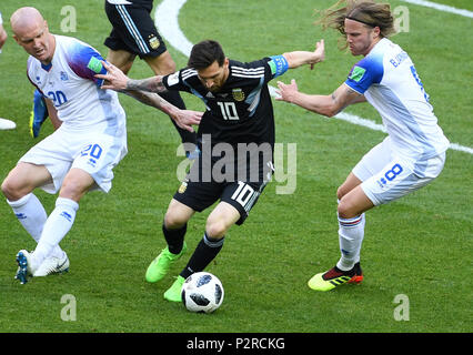 Moscow, Russia. 16th June, 2018. Emil Hallfredsson (L) and Birkir Bjarnason (R) of Iceland defend Lionel Messi of Argentina during a group D match between Argentina and Iceland at the 2018 FIFA World Cup in Moscow, Russia, June 16, 2018. Credit: Wang Yuguo/Xinhua/Alamy Live News Stock Photo