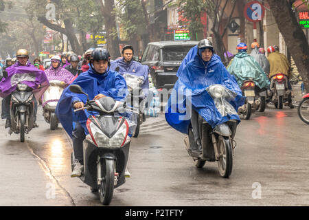 Motorcycles and riders on a wet day in Hanoi Vietnam Stock Photo