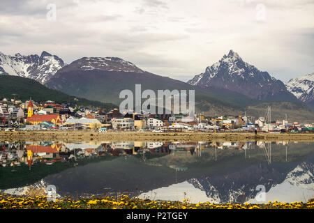 The 'Bahía Encerrada' mirrors the city of Ushuaia and its surrounding mountains. The scenery of this southernmost city is extraordinary. Stock Photo