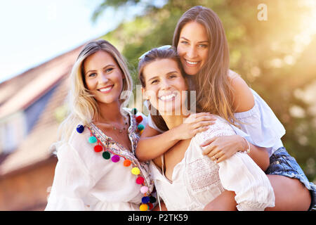 Happy girl friends hanging out in the city in summer Stock Photo