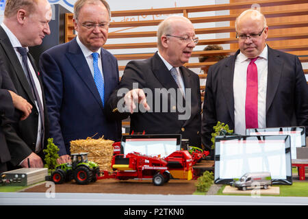 Hannover, Germany. 12th June, 2018. CEBIT 2018 opening walk with Peter Altmaier (R), Federal Minister or Economic Affairs and Energy Germany. Talking about Smart Farming at booth of German Research Center for Artificial Intelligence (DFKI) with Prof. Wolfgang Wahlster (CEO DFKI, 3rd L) and Stephan Weil (Prime Minister of Lower saxony (2nd L). CEBIT 2018, international computer expo and Europe's Business Festival for Innovation and Digitization. Credit: Christian Lademann Stock Photo
