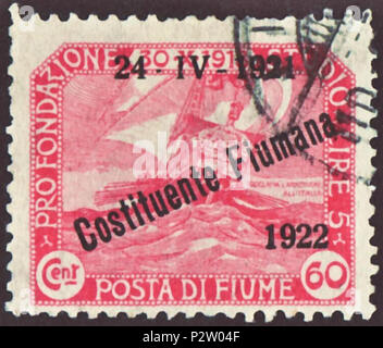 . Stamp of Fiume; 1922; commemorative stamp of the issue on the occasion of the opening of the Constituent Assembly in 1921; overprint type 'Costituente Fiumana - diagonale, with year number'; overprint on charity surcharge stamp of 1919 ('Proclamation of the Italian National Council from October 30, 1918 on the annexation of Rijeka to Italy'); motive: Venetian galley; postmarked; backside with dull green security print 'POSTA di FIUME' Stamp: Michel No. 148 (= No. 55 from 1919 with overprint) Color: carmine Watermark: none, but security print Nominal value: 60 Cent. (Centesimi) (+ 5 Lire as s Stock Photo