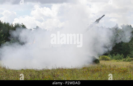 German Soldiers fire artillery during Exercise Flaming Thunder, August 2, 2016 at Kairiai, Lithuania. Flaming Thunder is a two-week long multinational fire coordination exercise and combined arms live fire to enhance interoperability among NATO fire support units, and to train and conduct joint fire support with the integration of maneuver elements, close air support, and close combat attack. The Soldiers from 1st Battalion, 41st Field Artillery Regiment, 1st Armor Brigade Combat Team, 3rd Infantry Division, involved in the exercise, are training with their Baltic allies in support of Operatio Stock Photo