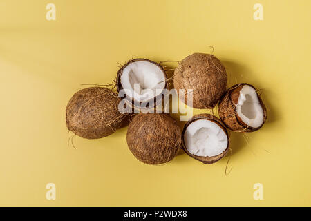 Coconuts on a pastel background, top view. Stock Photo