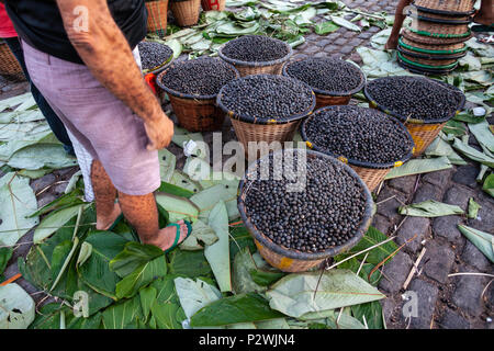 Straw basket full of fresh acai berries to sell at a fair in the city of Belem, Brazil. Stock Photo