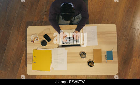 Young man working at a computer in a call centre Stock Photo