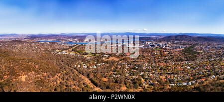 Over Canberra city CBD and government district on shores of lake Burley Griffin from elevated hill of Mount Ainslie on a sunny day. Stock Photo