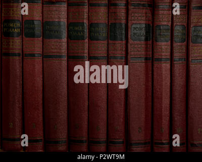old aged red books on the shelf backgrounds Stock Photo
