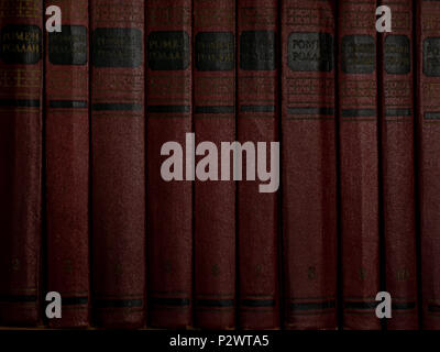 old aged red books on the shelf backgrounds Stock Photo