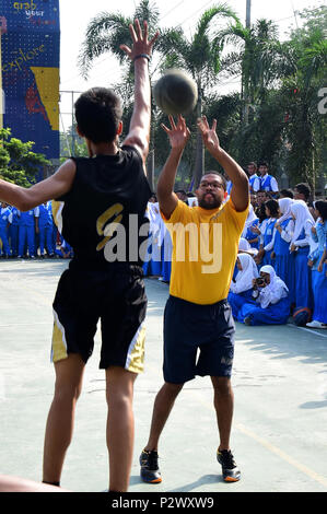 In Surabaya, Indonesia on August 3, 2016, U.S. Navy personnel participating in Cooperation Afloat Readiness and Training (CARAT) Indonesia 2016 engaged local students in a community outreach basketball game at a senior high school. CARAT is an annual series of maritime exercises conducted with partner nations to enhance maritime cooperation, build relationships and support community engagement alongside naval training, logistics and interoperability activities. Stock Photo