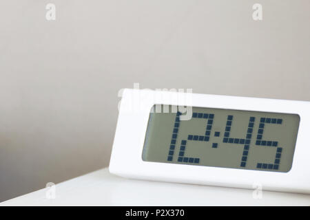 White clock digital modern on white table in bedroom. Stock Photo
