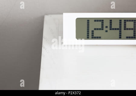 White clock digital modern on white table in bedroom. Stock Photo