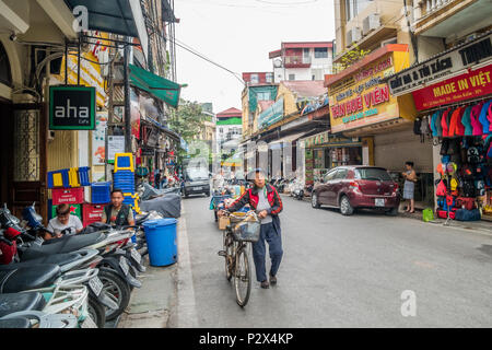 Hanoi,Vietnam - November 6,2017 : Local daily life of the street in Hanoi, Vietnam. Street vendors selling various types of vegetables from bicycle. Stock Photo