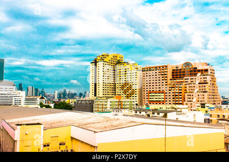 Bird view over cityscape and construction site including several cranes working on a building complex, with sun and clouds in the morning.Copy space.B Stock Photo