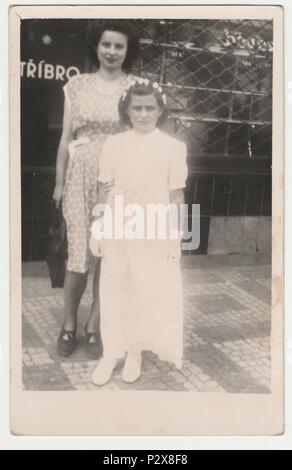 THE CZECHOSLOVAK SOCIALIST REPUBLIC - CIRCA 1950s: Vintage photo shows mother and daughter after her first communion.  Retro black & white  photography. Stock Photo