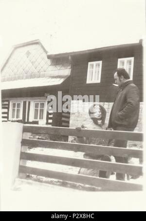 THE CZECHOSLOVAK SOCIALIST REPUBLIC - CIRCA 1970s: Vintage photo shows people in front of house. Retro black & white  photography. Stock Photo
