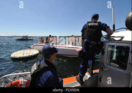 Boaters count the life jackets aboard their vessel for Coast Guard Maritime Safety and Security Team 91101 members as part of a safety check during Seattle's Seafair events on Lake Washington, Aug. 5, 2016. Coast Guard crews conducted spot inspections during Seafair to ensure required safety gear was on board and operational.  U.S. Coast Guard photo by Petty Officer 2nd Class Ayla Kelley. Stock Photo