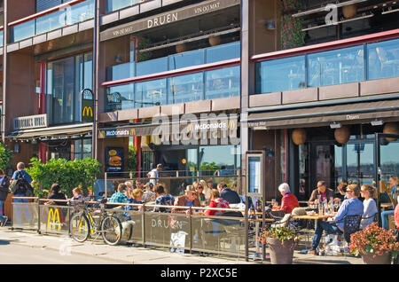 OSLO, NORWAY - APRIL 12, 2010: People in  McDonald's restaurant on the waterfront in the Aker Brygge area Stock Photo