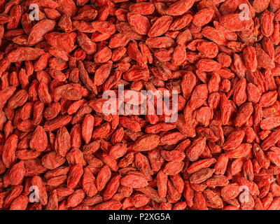 Detail high resolution closeup photo of goji berry (wolfberry - Lycium chinense) dried fruits heap shot from above. Stock Photo