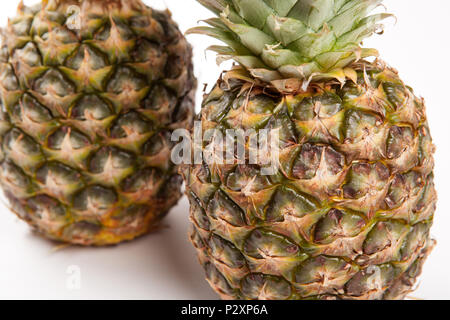two big pineapples on a white background closeup Stock Photo
