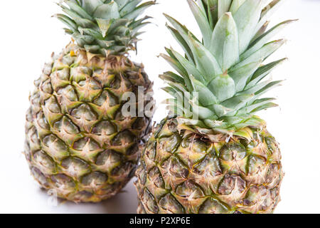 two big pineapples on a white background closeup Stock Photo