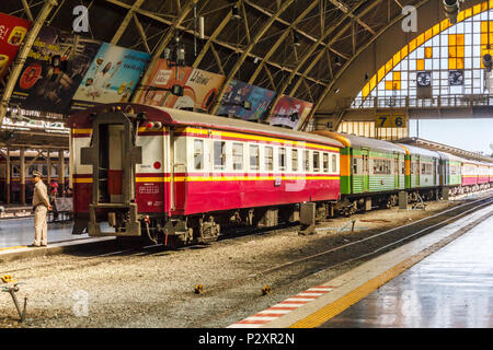 Bangkok, Thailand-19th March 2018: Guard standing by passenger train, Hua Lamphong station. This is the main railway station. Stock Photo