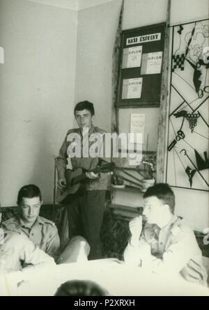 THE CZECHOSLOVAK SOCIALIST REPUBLIC - CIRCA 1970s: Retro photo shows young man (soldier) plays the guitar. Vintage photography. Stock Photo