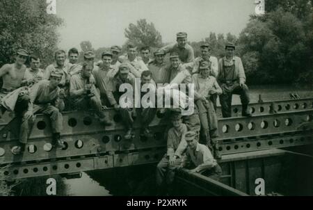 THE CZECHOSLOVAK SOCIALIST REPUBLIC - CIRCA 1970s: Retro photo shows combat engineers (sappers) pose on the bridge construction. Vintage photography. Stock Photo