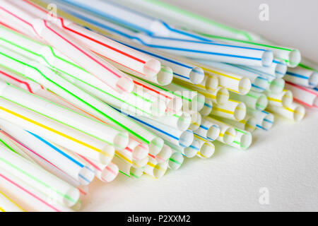 Close up of colourful plastic straws against white background Stock Photo