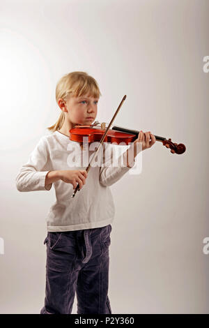 Young girl in the early stages of learning the violin Stock Photo