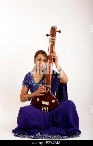 Tanpura with four strings, Indian string instrument in playing position Stock Photo