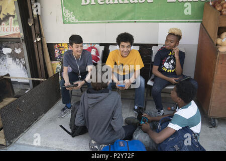 Middle school aged boys relax in front of alocal deli after school