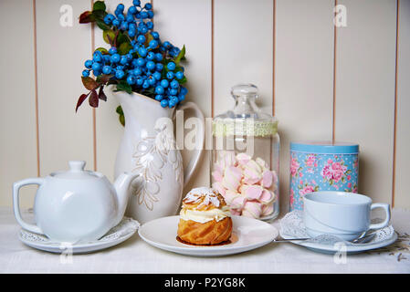 Pastry on a plate standing on a served decorated table. Stock Photo