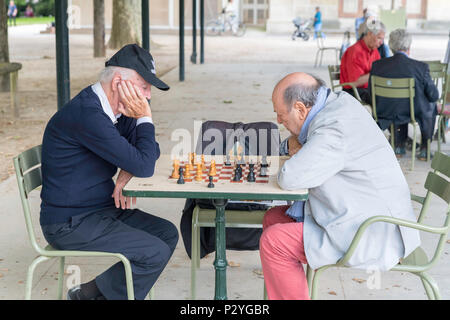 Paris, France - June 15, 2018: People playing chess in Jardin du Luxembourg (Luxembourg Garden). Luxembourg Garden is one of the most popular Parisian Stock Photo