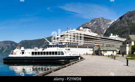 Eidfjord, Norway - May 21, 2018: Travel documentary of everyday life and place. Luxury cruise ship Viking Sun and the smaller ferry Teisten moored in  Stock Photo