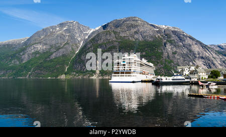 Eidfjord, Norway - May 21, 2018: Travel documentary of everyday life and place. Luxury cruise ship Viking Sun and the smaller ferry Teisten moored in  Stock Photo