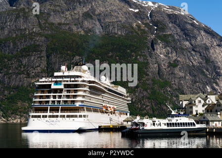 Eidfjord, Norway - May 21, 2018: Travel documentary of everyday life and place. Luxury cruise ship Viking Sun and the smaller ferry Teisten moored in  Stock Photo